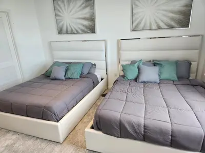 two beds sitting next to each other in a bedroom at Wonderful 1 bedroom condo in Midtown. in Miami