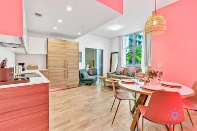 a kitchen and a living room with a table and chairs at Cozy Apartment - Hot Tub - NearBeach - Broad - walk in Hollywood