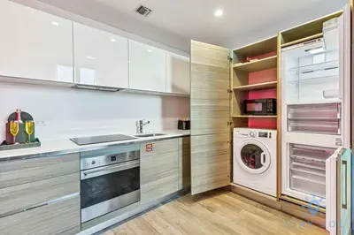 a kitchen with white cabinets and a washer and dryer at Cozy Apartment - Hot Tub - NearBeach - Broad - walk in Hollywood