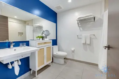 a bathroom with a white sink and a toilet at Exclusive Apartment - Rooftop Pool - Hollywood Beach in Hollywood
