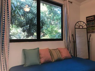 a bedroom with a bed with a large window at Private and Comfy Cabin near to MIA airport in Miami