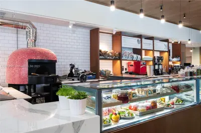 a display case in a bakery with a lot of food at Stylish 1 BR at Fort Lauderdale in Fort Lauderdale