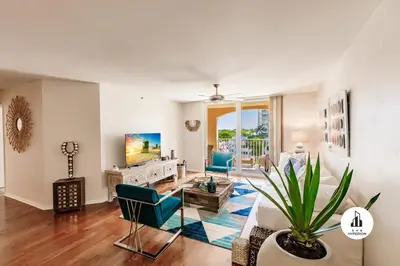 a living room with a couch and a tv at Uhost AI - 3BR Condo - Stunning Water Views in Miami