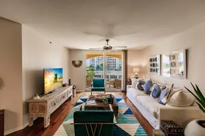 a living room with a white couch and a tv at Uhost AI - 3BR Condo - Stunning Water Views in Miami