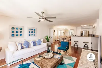a living room with a white couch and a ceiling fan at Uhost AI - 3BR Condo - Stunning Water Views in Miami