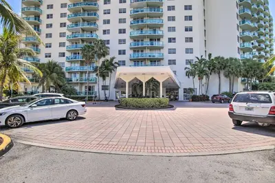 a parking lot with cars parked in front of a building at Less Than Half-Mi to Beach Sunny Isles Resort Condo in Miami Beach