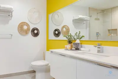 a bathroom with a toilet and a sink and a mirror at Hollywood Beach Broad - walk - Gym - Amazing Pool in Hollywood