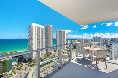 a balcony with a table and a view of the ocean at Wrap Around Balcony - 2Br - Amazing Views - Pools in Hollywood
