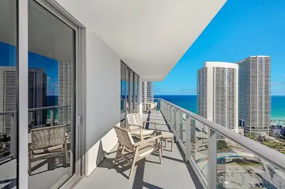 a balcony with chairs and a view of the ocean at Wrap Around Balcony - 2Br - Amazing Views - Pools in Hollywood
