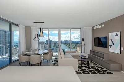 a living room with a couch and a table at Wrap Around Balcony - 2Br - Amazing Views - Pools in Hollywood