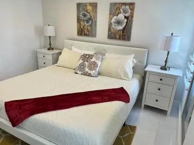 a bedroom with a white bed with two night stands at Direct Ocean View - Luxurious condo in South Beach in Miami Beach