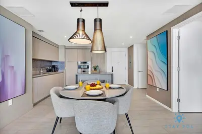 a kitchen and dining room with a table and chairs at Sophisticated Coastal Haven, Parking Included in Hollywood
