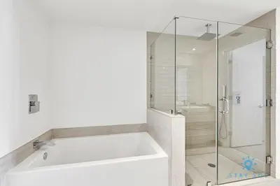 a white bathroom with a tub and a shower at Sophisticated Coastal Haven, Parking Included in Hollywood