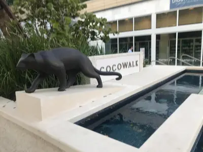 a statue of a black cat sitting on top of a building at Key West Style Historic Home in Coconut Grove Florida The Yellow House in Miami