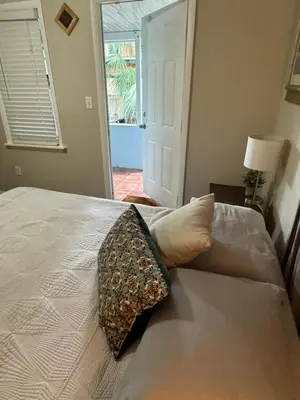 a bedroom with a bed with a pillow on it at Key West Style Historic Home in Coconut Grove Florida, The Blue House in Miami