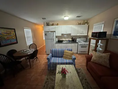 a kitchen and living room with a couch and a table at Key West Style Historic Home in Coconut Grove Florida, The Blue House in Miami