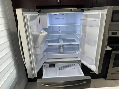 an empty refrigerator with its door open in a kitchen at Vacay Spot experience Luna Sky! 65