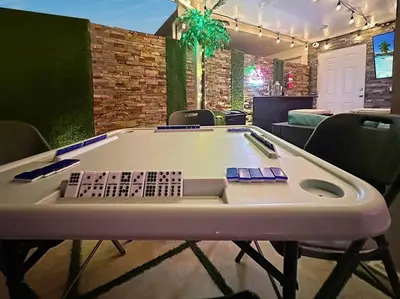 a ping pong table in a room with chairs at Vacay Spot experience Luna Sky! 65