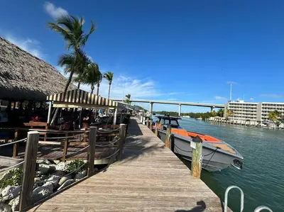 a boat is docked at a dock on the water at Vacay Spot experience Luna Sky! 65