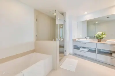 a white bathroom with two sinks and a mirror at Zen Vacation Rentals Ocean front 3 3 MAZAL in Hollywood