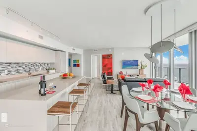 a kitchen and dining room with a table and chairs at Zen Vacation Rentals Ocean front 3 3 MAZAL in Hollywood