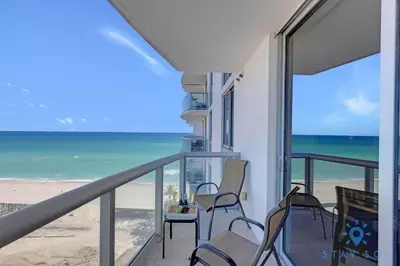 a balcony with chairs and a view of the beach at Beachfront Resort - Pool - Ocean View Balcony- Gym in Miami Beach