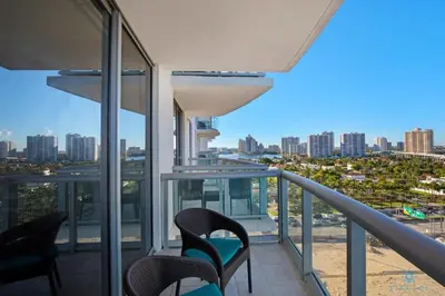 a balcony with chairs and a view of the city at Beachfront Resort POOL OCEAN VIEW BALCONY in Miami Beach
