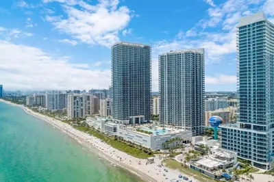 an aerial view of a beach with tall buildings at Zen Vacation Rentals Ocean Front at Lyfe Resort in Hollywood