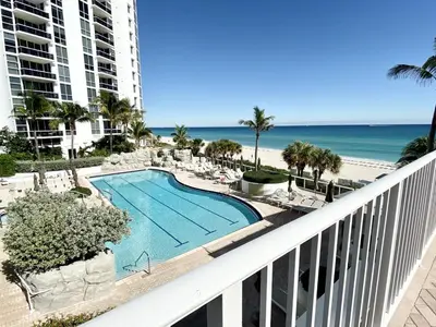 a view of the beach from the balcony of a resort at Trump International Resort by Zen Vacation Rentals in Miami Beach