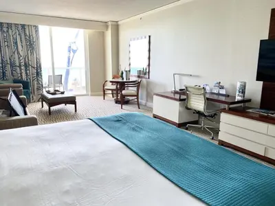 a hotel room with a large bed and a desk at Trump International Resort by Zen Vacation Rentals in Miami Beach