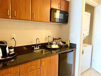 a kitchen with a sink and a microwave at Trump International Resort by Zen Vacation Rentals in Miami Beach