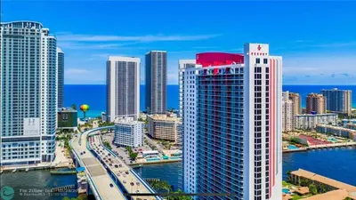 a view of a city with a river and buildings at BeachWalk Studio Steps from the Sand 2 Full Beds 805 B in Hallandale Beach