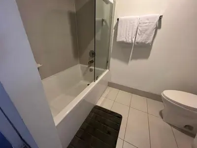 a bathroom with a shower and a toilet at Designer Beachfront Apartment Views, Luxury & Full Kitchen 805 A in Hallandale Beach