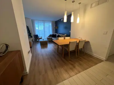 a dining room and living room with a table and chairs at Designer Beachfront Apartment Views, Luxury & Full Kitchen 805 A in Hallandale Beach