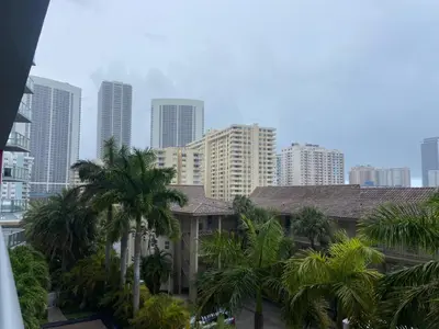 a city skyline with tall buildings and palm trees at Charming Room by the Beach Pure Relaxation 2004 B in Hallandale Beach