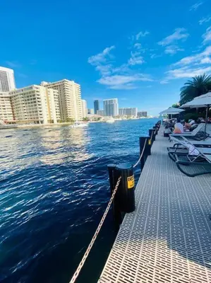 a pier with boats in the water next to buildings at Charming Room by the Beach Pure Relaxation 2004 B in Hallandale Beach