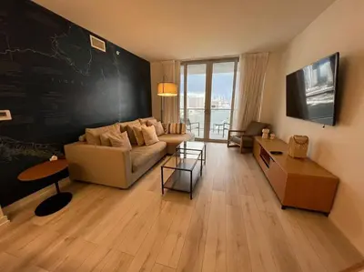 a living room with a couch and a chalkboard wall at Luxury Stay in Miami Beach Stunning Views & Full Kitchen 20A in Hallandale Beach