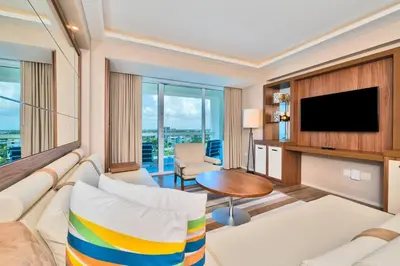 a living room with a couch and a television at Luxury 1 BR Suite at Fort Lauderdale in Fort Lauderdale