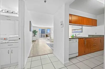 a kitchen with white cabinets and a white floor at Amazing 1 Bed 1 Bath • Brickell • City & Bay View in Miami
