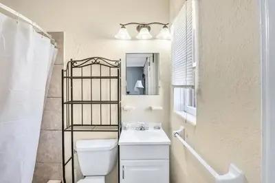 a bathroom with a sink and a toilet and a mirror at Charter House in Hollywood