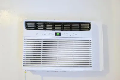 a white air conditioner sitting on a wall at 5 Minutes to downtown Apt201 in Miami