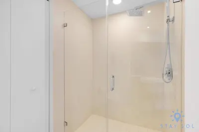 a shower with a glass door in a bathroom at Insane Ocean View Balcony - Beachfront Condo - Pool in Hollywood