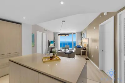 a kitchen and living room with a view of the ocean at Insane Ocean View Balcony - Beachfront Condo - Pool in Hollywood