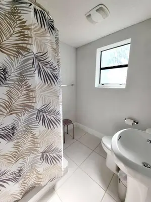 a bathroom with a toilet and a shower curtain at Lovely Apartment Near Brickell 3 in Miami