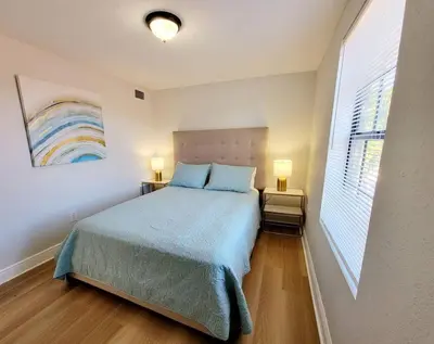 a bedroom with a bed and a rainbow painting on the wall at Lovely Apartment Near Brickell 3 in Miami