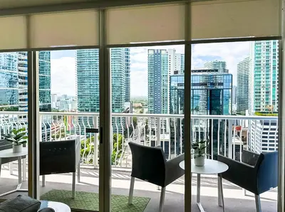 a room with a view of a city with tables and chairs at Top Stay Miami Green Brickell in Miami