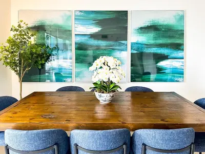 a dining room table with a vase of flowers on it at Top Stay Miami Green Brickell in Miami