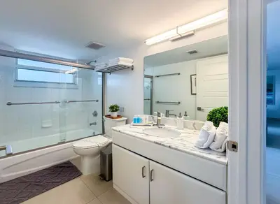 a bathroom with a sink and a toilet and a mirror at Top Stay Miami Green Brickell in Miami