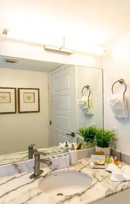 a bathroom with a sink and a large mirror at Top Stay Miami Green Brickell in Miami