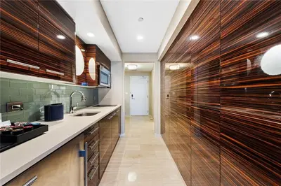 a large kitchen with wooden cabinets and a sink at Luxury Suite at Fort Lauderdale in Fort Lauderdale